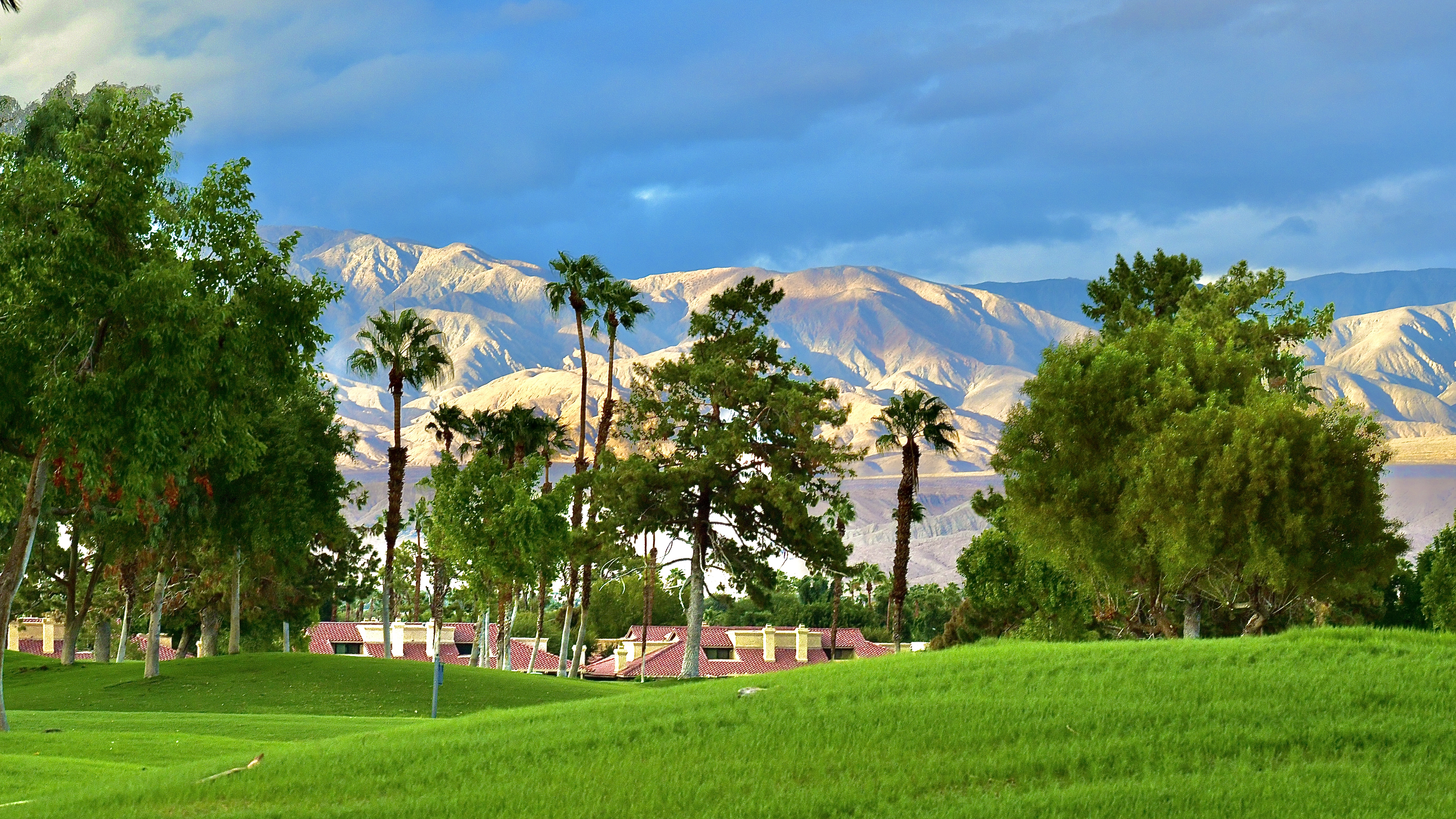 Golf course fairway with mountains in distance