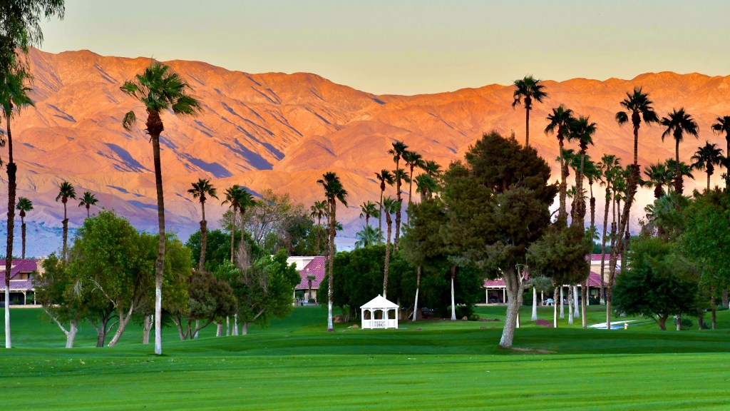 Mountains behind golf course at sunset